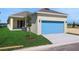 Home exterior features a two-car garage, pristine lawn, and a young shade tree at 5125 Waypointe Blvd, Apopka, FL 32712