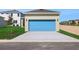 Exterior of home featuring a two-car garage and large concrete driveway at 5125 Waypointe Blvd, Apopka, FL 32712