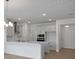 Well-lit kitchen with gray cabinets, a kitchen island, and stainless steel appliances at 5125 Waypointe Blvd, Apopka, FL 32712