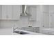New kitchen features gray cabinets, a stainless steel vent hood, and modern appliances at 5125 Waypointe Blvd, Apopka, FL 32712