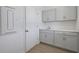 Well-lit laundry room with sink, gray cabinetry, and convenient access to the exterior at 5125 Waypointe Blvd, Apopka, FL 32712