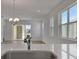 Bright living room with light wood floors, large windows, and modern lighting at 5125 Waypointe Blvd, Apopka, FL 32712