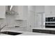 Close-up of a modern kitchen with white counters, tiled backsplash and stainless steel appliances at 5129 Blanket Flower St, Apopka, FL 32712