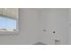 Bright laundry room featuring a window with blinds, utility connections, and tiled floors at 5129 Blanket Flower St, Apopka, FL 32712