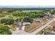 Aerial view of a single-story home with lake views and an expansive lot, as well as mature landscaping at 529 Ed Douglas Rd, Groveland, FL 34736