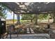 Shaded backyard patio with string lights, a grill, and views of the spacious, fenced yard at 529 Ed Douglas Rd, Groveland, FL 34736