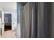 Bathroom view includes a bathtub with shower curtain, toilet, and a partial view of the bedroom at 529 Ed Douglas Rd, Groveland, FL 34736