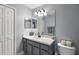 Well-lit bathroom with a single sink vanity, large mirror, and modern fixtures at 529 Ed Douglas Rd, Groveland, FL 34736