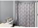 Clean bathroom with a shower featuring a decorative curtain and toilet at 529 Ed Douglas Rd, Groveland, FL 34736