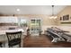 Bright dining area with hardwood floors, modern lighting, and views of outdoor space through sliding glass door at 529 Ed Douglas Rd, Groveland, FL 34736