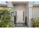 Inviting front entrance with white door, decorative accents, and manicured bushes providing curb appeal at 529 Ed Douglas Rd, Groveland, FL 34736