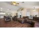 Spacious living room seamlessly connects to dining area, featuring hardwood floors and comfortable seating at 529 Ed Douglas Rd, Groveland, FL 34736