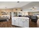 Open-concept living area with a dining table, island, and comfortable leather furniture at 529 Ed Douglas Rd, Groveland, FL 34736