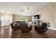 Spacious living room features hardwood floors, cozy seating, ceiling fan, and a decorative fireplace at 529 Ed Douglas Rd, Groveland, FL 34736