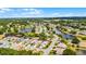 Aerial view of a residential neighborhood with winding roads, lush trees, and scenic lake views at 5500 Laver St, Leesburg, FL 34748