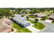 Real estate showcasing well-manicured lawn, mature trees, and a two car garage at 5500 Laver St, Leesburg, FL 34748