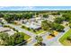 Community aerial view showcasing a home with mature trees and well-maintained lawns at 5500 Laver St, Leesburg, FL 34748