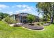 Picture of the exterior of screened in back porch with lovely landscaping at 5500 Laver St, Leesburg, FL 34748