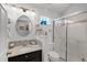 Stylish bathroom with a glass-enclosed shower and modern vanity with a granite countertop at 5500 Laver St, Leesburg, FL 34748