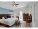Cozy bedroom featuring a king-sized bed and decorative chest, leading to ensuite bathroom at 5500 Laver St, Leesburg, FL 34748