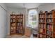 Inviting bedroom featuring bookshelves and a sunlit window, creating a cozy reading nook at 5500 Laver St, Leesburg, FL 34748