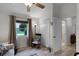 Bright bedroom with a rocking chair, neutral tones, and access to an ensuite bathroom at 5500 Laver St, Leesburg, FL 34748