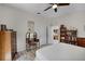 Serene bedroom with a makeup vanity, ceiling fan, and natural light throughout at 5500 Laver St, Leesburg, FL 34748