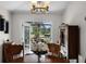 Cozy dining room with wood table set and french doors leading to the outside space at 5500 Laver St, Leesburg, FL 34748