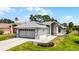 Desirable one-story home with a two-car garage, well-kept landscaping, and inviting facade at 5500 Laver St, Leesburg, FL 34748