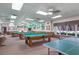 Inviting game room featuring multiple billiard tables and a ping pong table for endless entertainment at 5500 Laver St, Leesburg, FL 34748