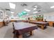 Well-equipped game room with billiard tables covered to keep them clean and ready for play at 5500 Laver St, Leesburg, FL 34748