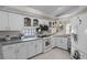 Well-lit kitchen with white cabinets, stone countertops, modern appliances, and a stainless-steel microwave at 5500 Laver St, Leesburg, FL 34748