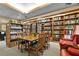 Inviting library space with ample shelving and a comfortable reading area and cozy red armchairs at 5500 Laver St, Leesburg, FL 34748
