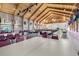 Large meeting room featuring high ceilings, rows of tables and chairs, and many flags at 5500 Laver St, Leesburg, FL 34748