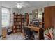 Home office with ceiling fan, built-in bookshelves, and space for a desk and computer at 5500 Laver St, Leesburg, FL 34748