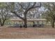 Outdoor picnic pavilion with metal roof, several tables, and barbecue grills nearby at 5500 Laver St, Leesburg, FL 34748