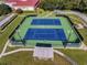 Overhead view of tennis courts highlighting the lighting and shade structure at 5500 Laver St, Leesburg, FL 34748