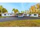 Single story home featuring a large driveway, manicured lawn, and mature trees at 5526 Parkdale Dr, Orlando, FL 32839