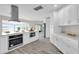 Bright, open kitchen with white cabinets, stainless steel appliances, and a view of the lake at 5526 Parkdale Dr, Orlando, FL 32839