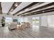 Bright living room features wood-beamed ceiling, lake views, and contemporary furnishings at 5526 Parkdale Dr, Orlando, FL 32839