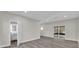 Living space features gray plank flooring, recessed lights, access to a full bathroom at 5526 Parkdale Dr, Orlando, FL 32839