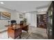 Home office space with a large wooden desk, built-in bookcase, and comfortable seating at 5526 Parkdale Dr, Orlando, FL 32839