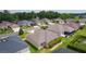 Aerial view of a suburban neighborhood with mature trees and green lawns at 5596 Cedar Waxwing Dr, The Villages, FL 32163