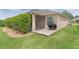 Well-maintained backyard with a screened-in patio and a barbecue grill on a concrete slab at 5596 Cedar Waxwing Dr, The Villages, FL 32163