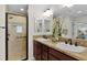 Bathroom featuring double sink vanity and glass-enclosed shower at 5596 Cedar Waxwing Dr, The Villages, FL 32163