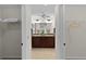 Bathroom view between closet spaces into double sink vanity at 5596 Cedar Waxwing Dr, The Villages, FL 32163