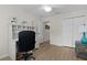 Bright bedroom featuring a built-in desk area and wood-look vinyl flooring at 5596 Cedar Waxwing Dr, The Villages, FL 32163