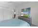 Bedroom featuring a TV, closet, ceiling fan and comfortable bed at 5596 Cedar Waxwing Dr, The Villages, FL 32163