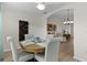The dining room is open to the living room and features modern decor at 5596 Cedar Waxwing Dr, The Villages, FL 32163