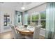 Bright dining room with a round table, upholstered chairs, and lots of natural light at 5596 Cedar Waxwing Dr, The Villages, FL 32163